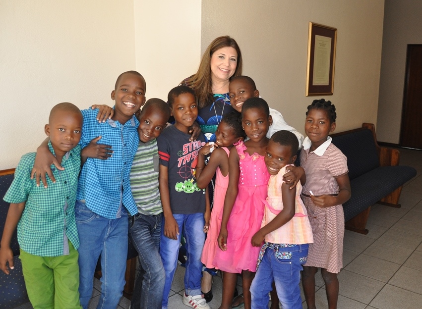 Sister Kretly is surrounded by loving children of new Beira Stake